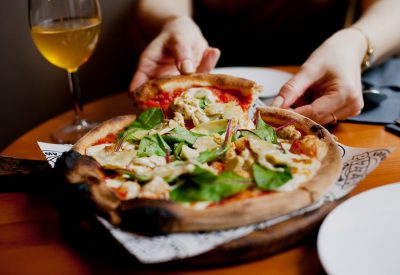 woman-eating-pizza-at-pizzeria-or-restaurant-2021-09-04-01-49-53-utc